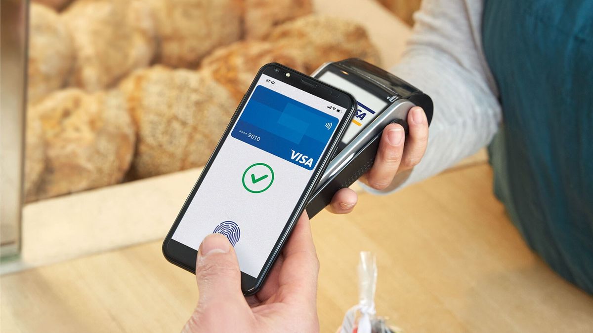 Person making a contactless payment with a smartphone using digital and virtual credit cards, highlighting security and convenience for online shopping.